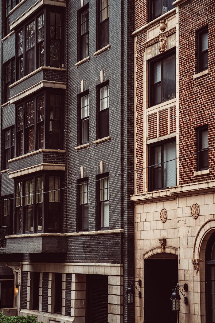 A modern facade blends with classic brick architecture in Chicago's urban landscape.