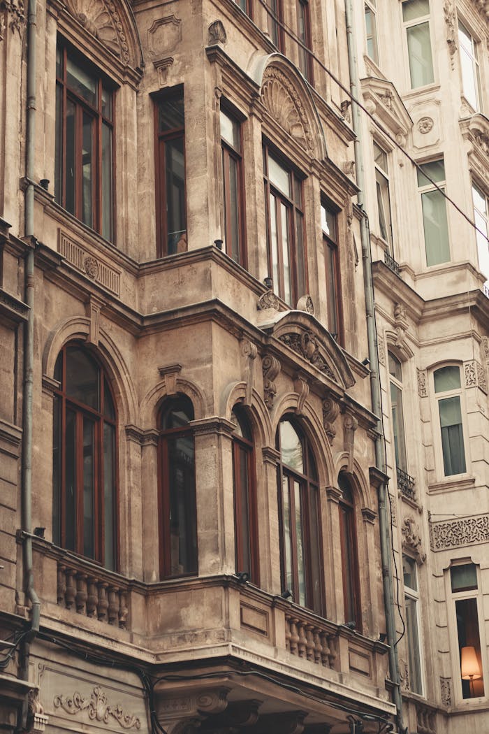 Detailed facade of an old urban building with classic architectural design and ornate windows.